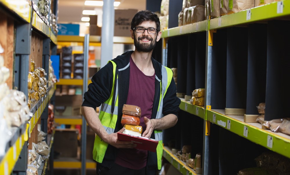 An Esssential worker picks an order in the warehouse