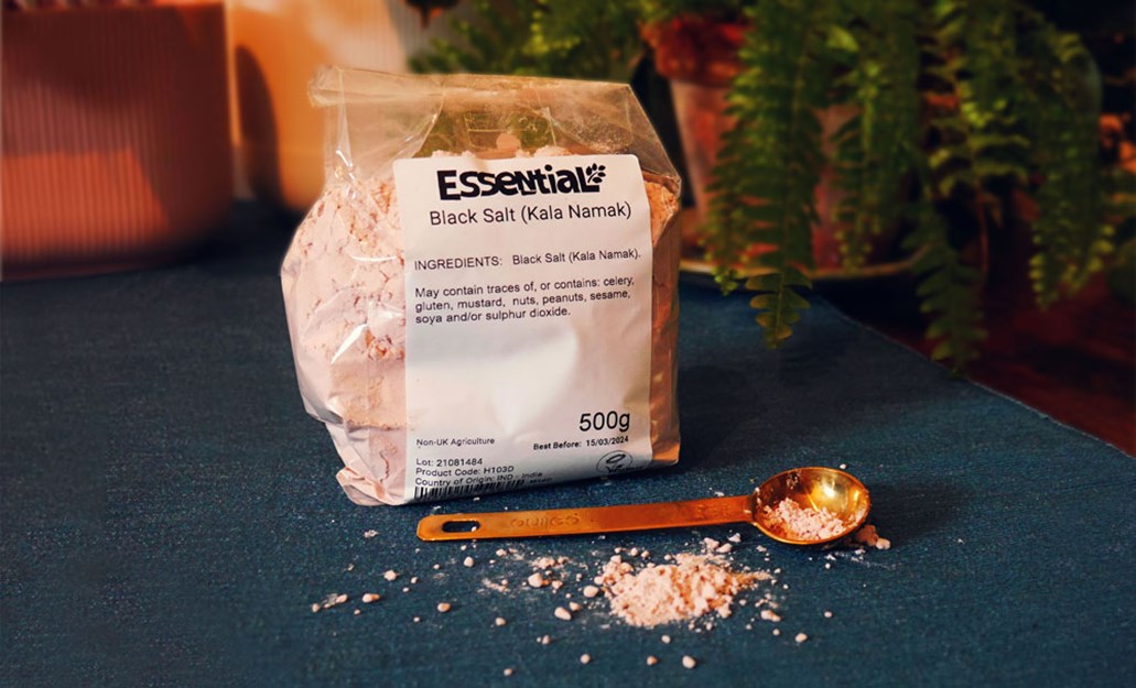 pack of black salt with a measuring spoon