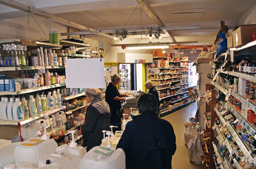 a high angle shot of christine servin a customer at the till